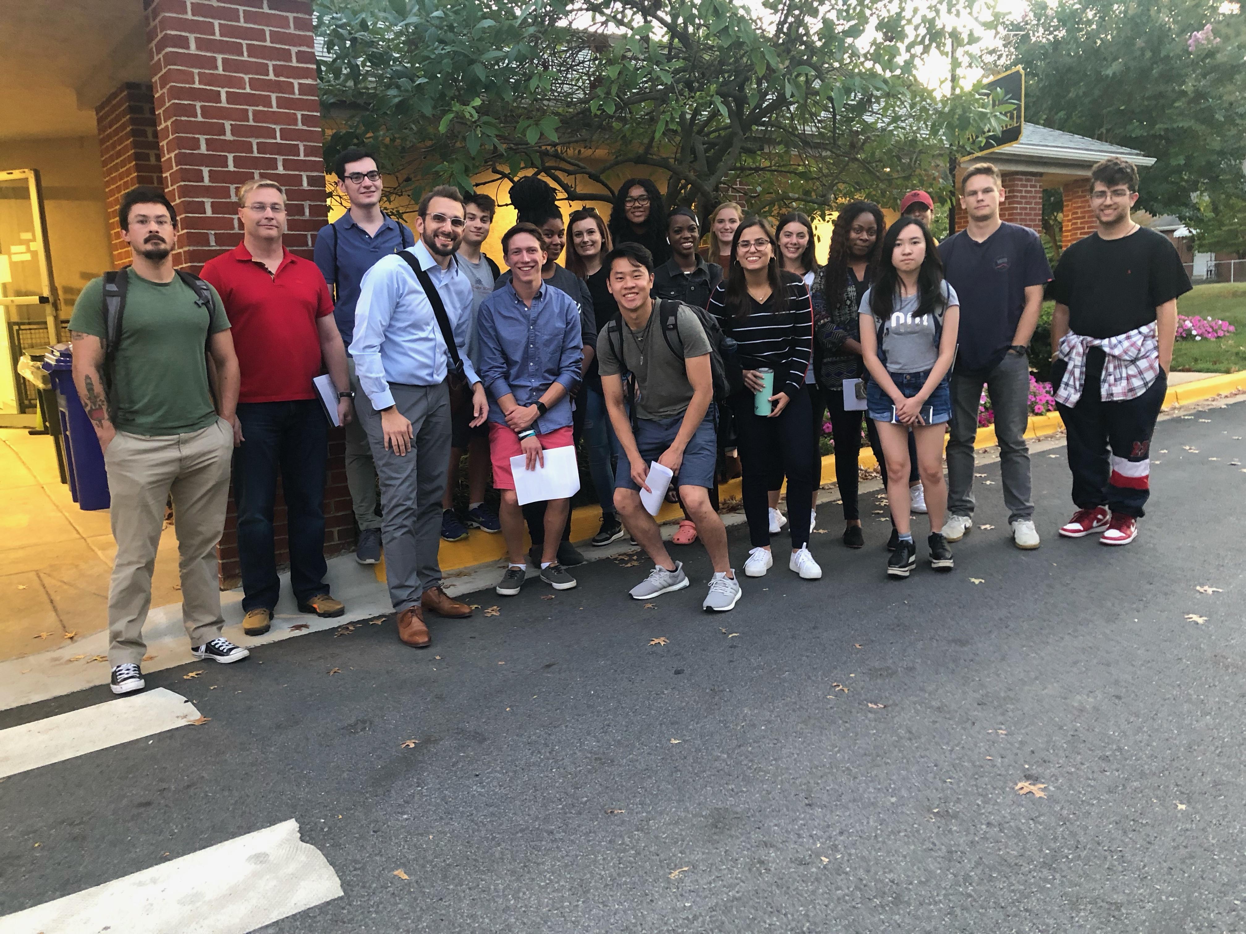 group of students pose outside building