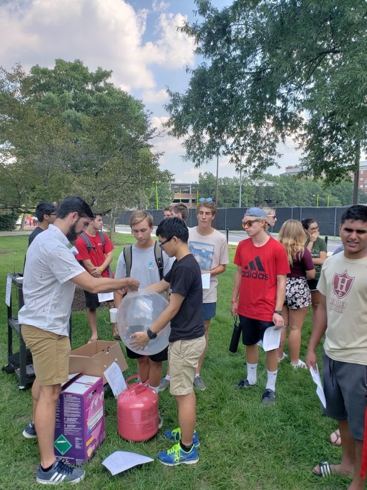 Students in the Weather & Climate community launching weather balloons