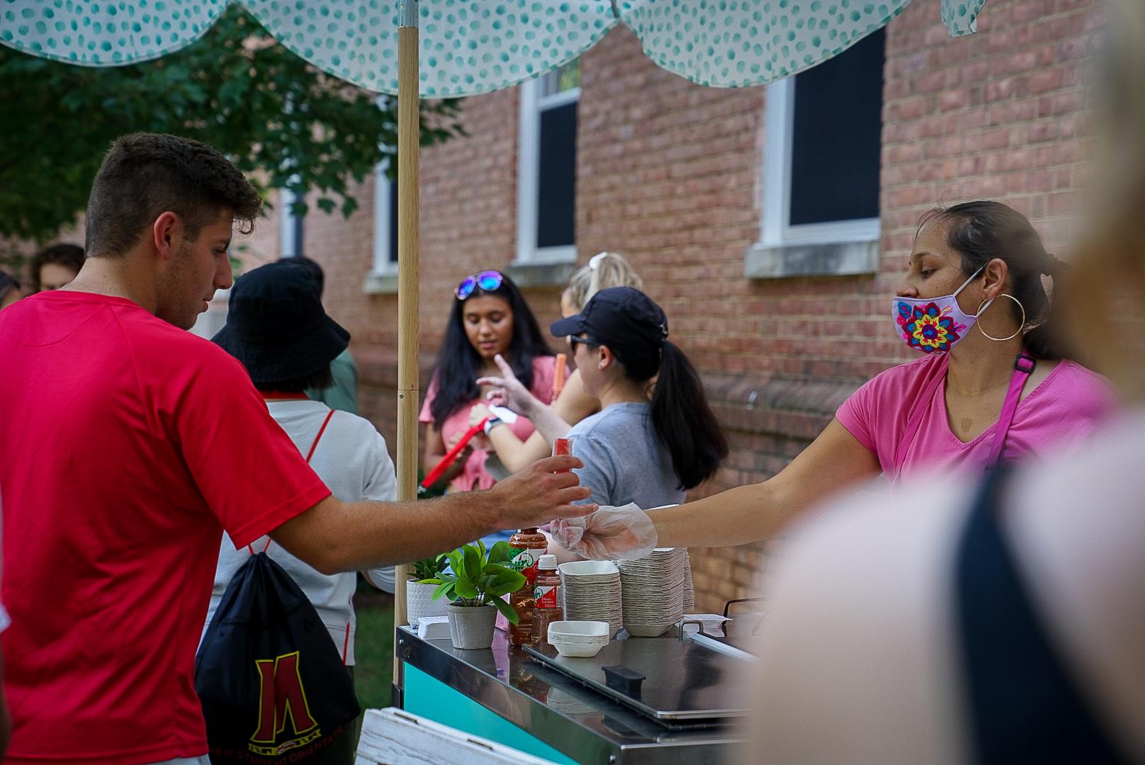 staff gives ice cream to student