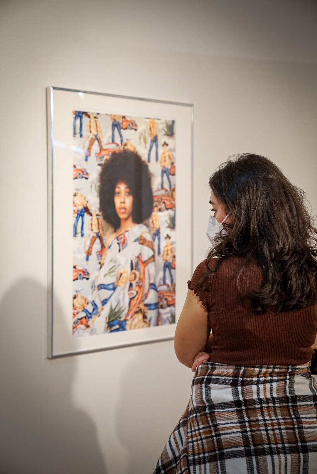 a student looking at a piece of artwork