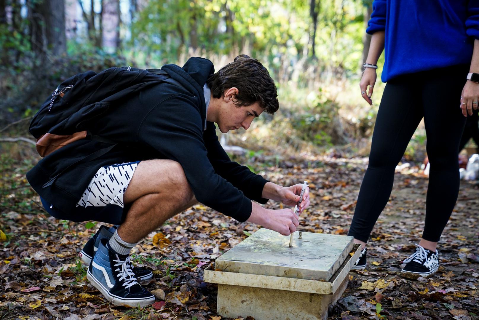 A student doing an experiment outside
