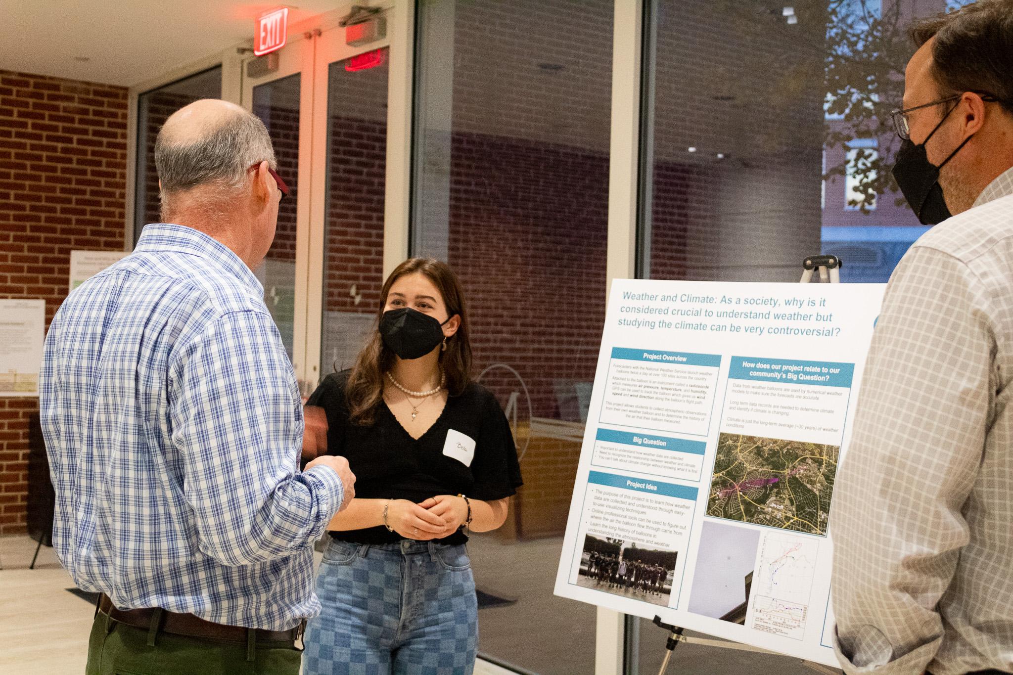 A student presenting a poster to a Carillon faculty member