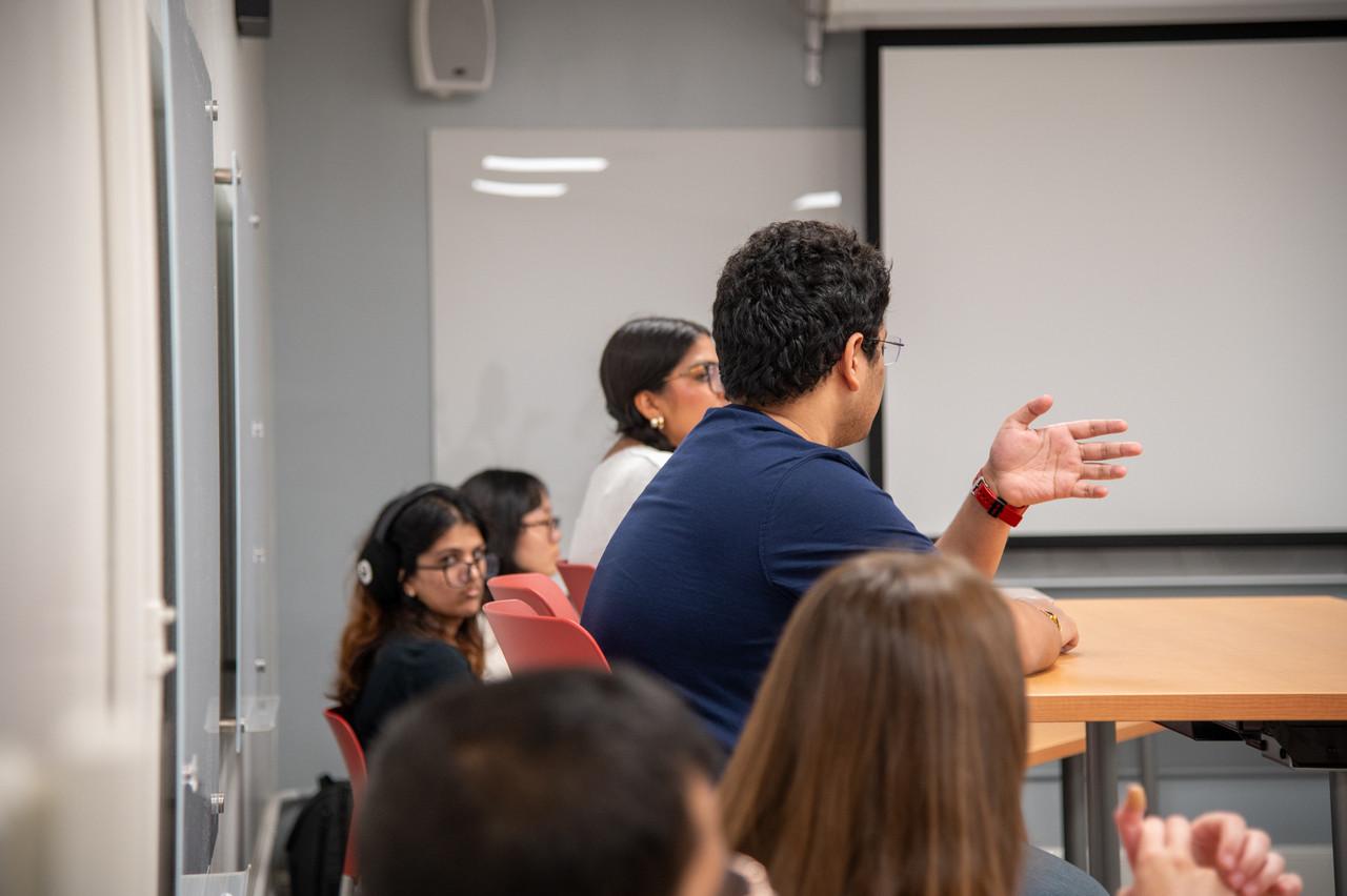 student facing other students with hand out