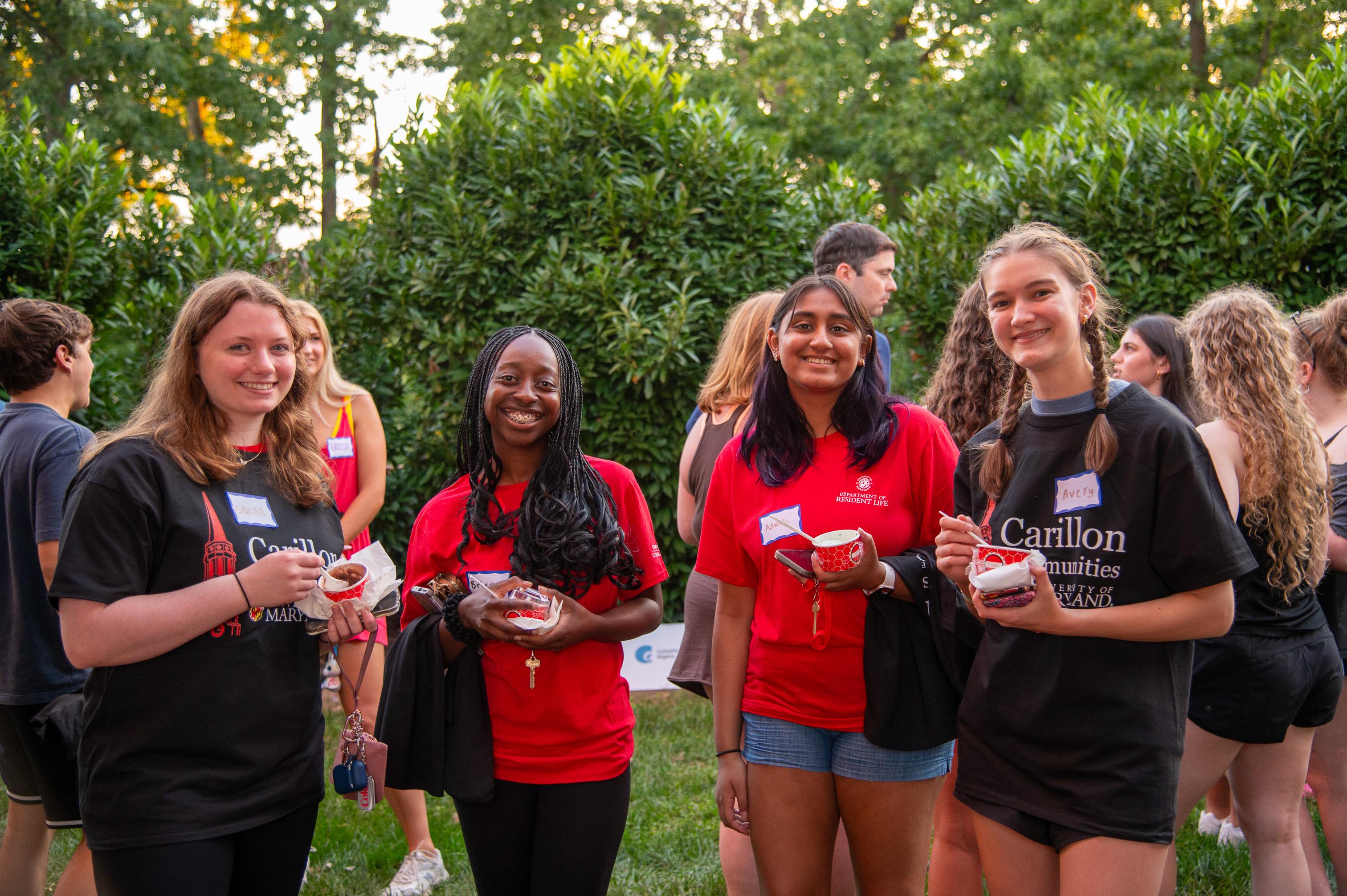 Four Carillon students pose for a photo holding ice cream cups